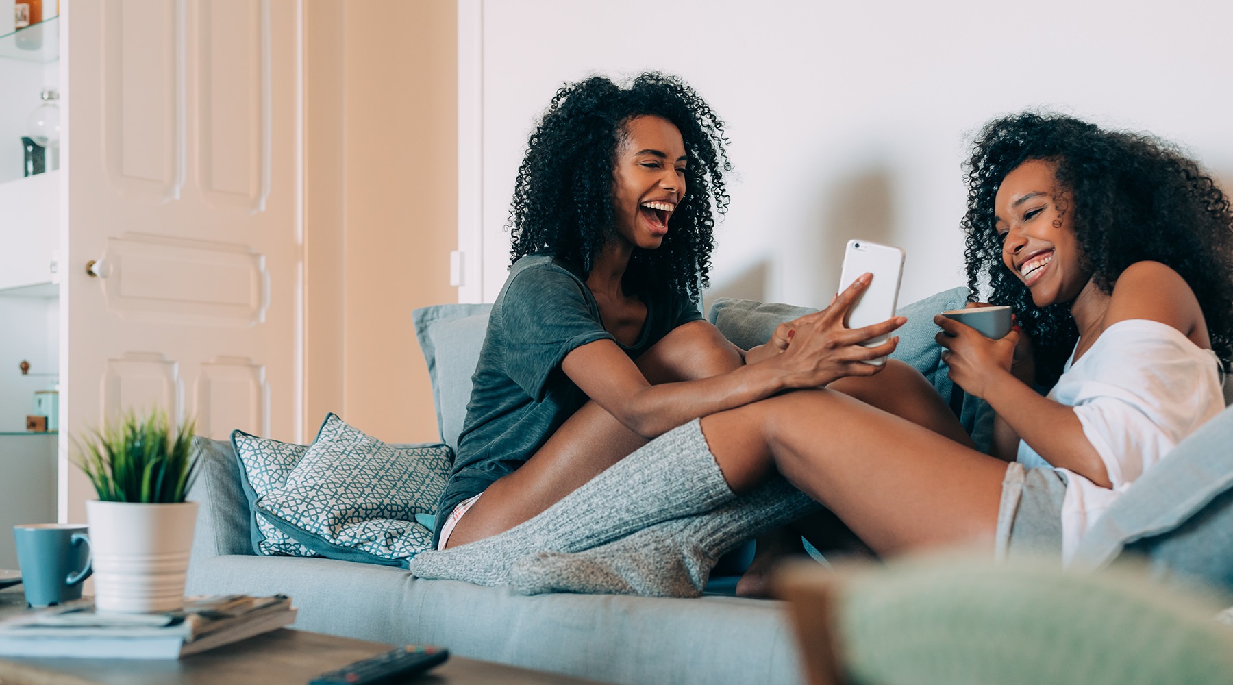 Welcome home friends laughing together on a couch