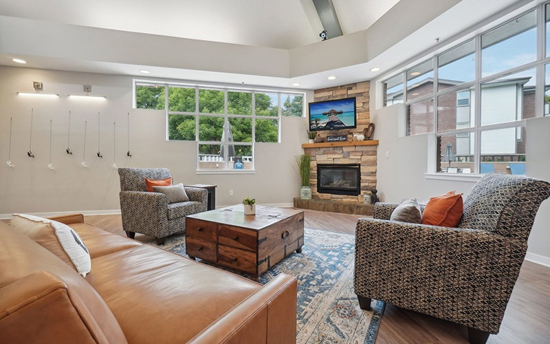 a lounge room with seating and a fireplace