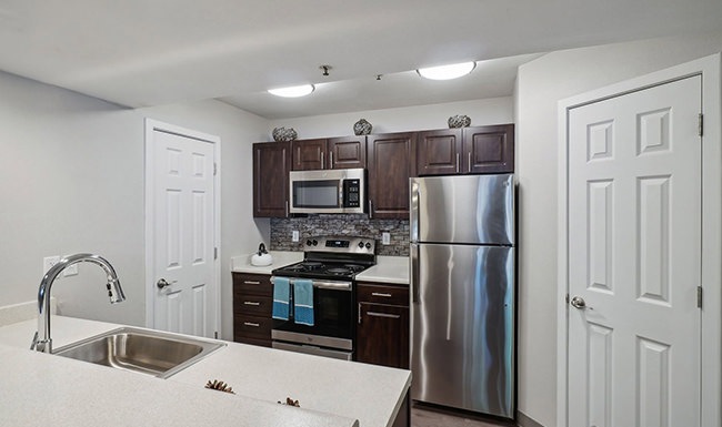 Spacious kitchens with thoughtful details kitchen with wooden cabinets and stainless steel appliances