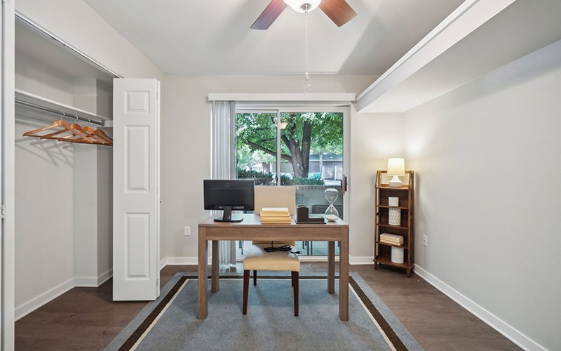 an office with a desk and a fan