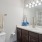 bathroom with large mirror and toilet