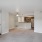 living room with carpet and a view of a kitchen